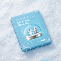 AIMX Christmas Mask Set blue gift box resting in snow, featuring a festive snow-globe design.