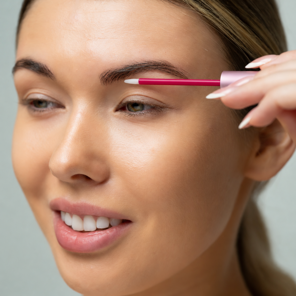 Lerelle Beauty Brows2Love Eyebrow Growth Serum applicator being brushed through the brows