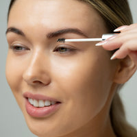 Lerelle Beauty Brows2Love eyebrow growth serum applicator being brushed through eyebrow