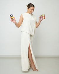 Alt text: Lerelle Beauty founder holding bottles of Ellips hair serum capsules