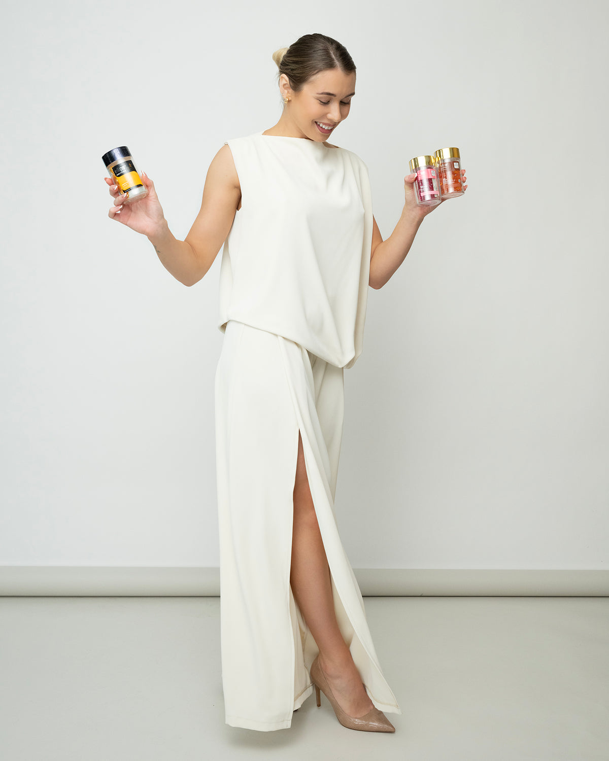 Alt text: Lerelle Beauty founder holding bottles of Ellips hair serum capsules