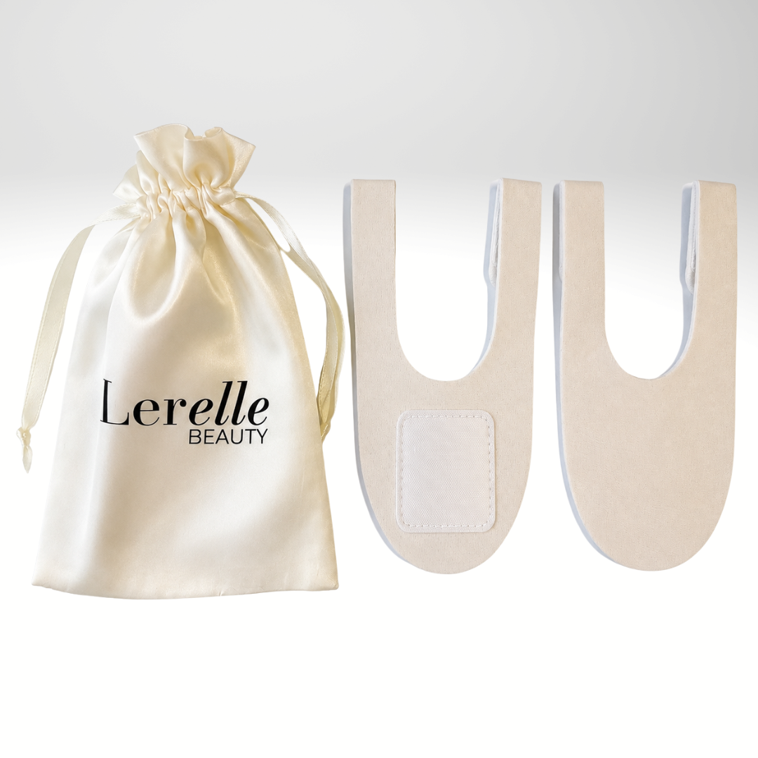 A beige satin drawstring pouch with 'Lerelle BEAUTY' printed in black, shown next to two beige U-shaped led face mask replacement straps on  a light gray gradient background.
