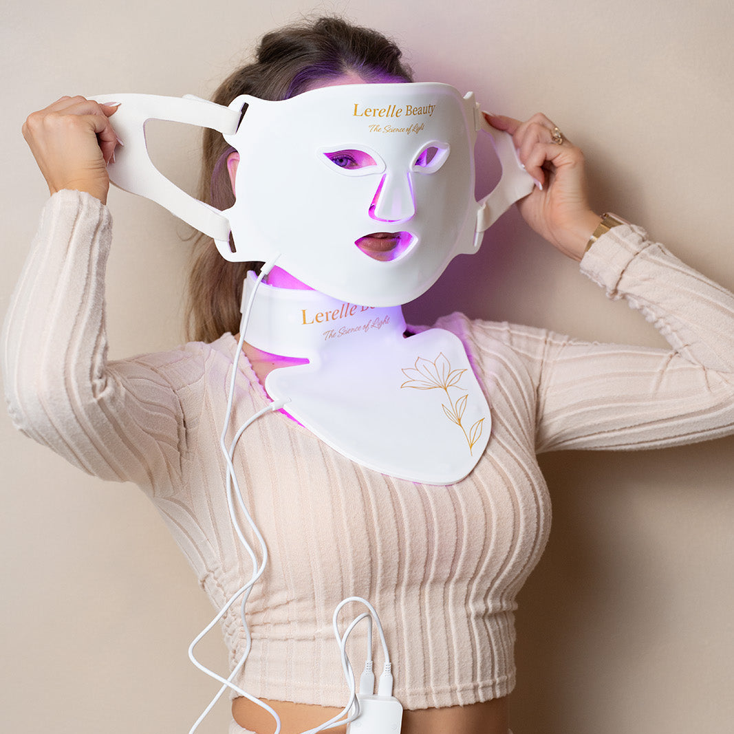 Lerelle Beauty LED face, neck and décolletage mask being put on, with the light glowing purple