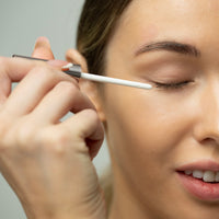 Lerelle Beauty Lashes2Love Lash Growth Serum wand applying formula along the upper lash line